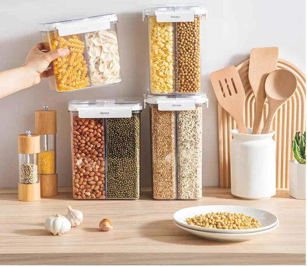 Various sizes of Multifunctional Kitchen Food Compartmentalized Airtight Storage Boxes are placed on the kitchen countertop, containing noodles, assorted grains, and cereals. The airtight boxes keep the food fresh.